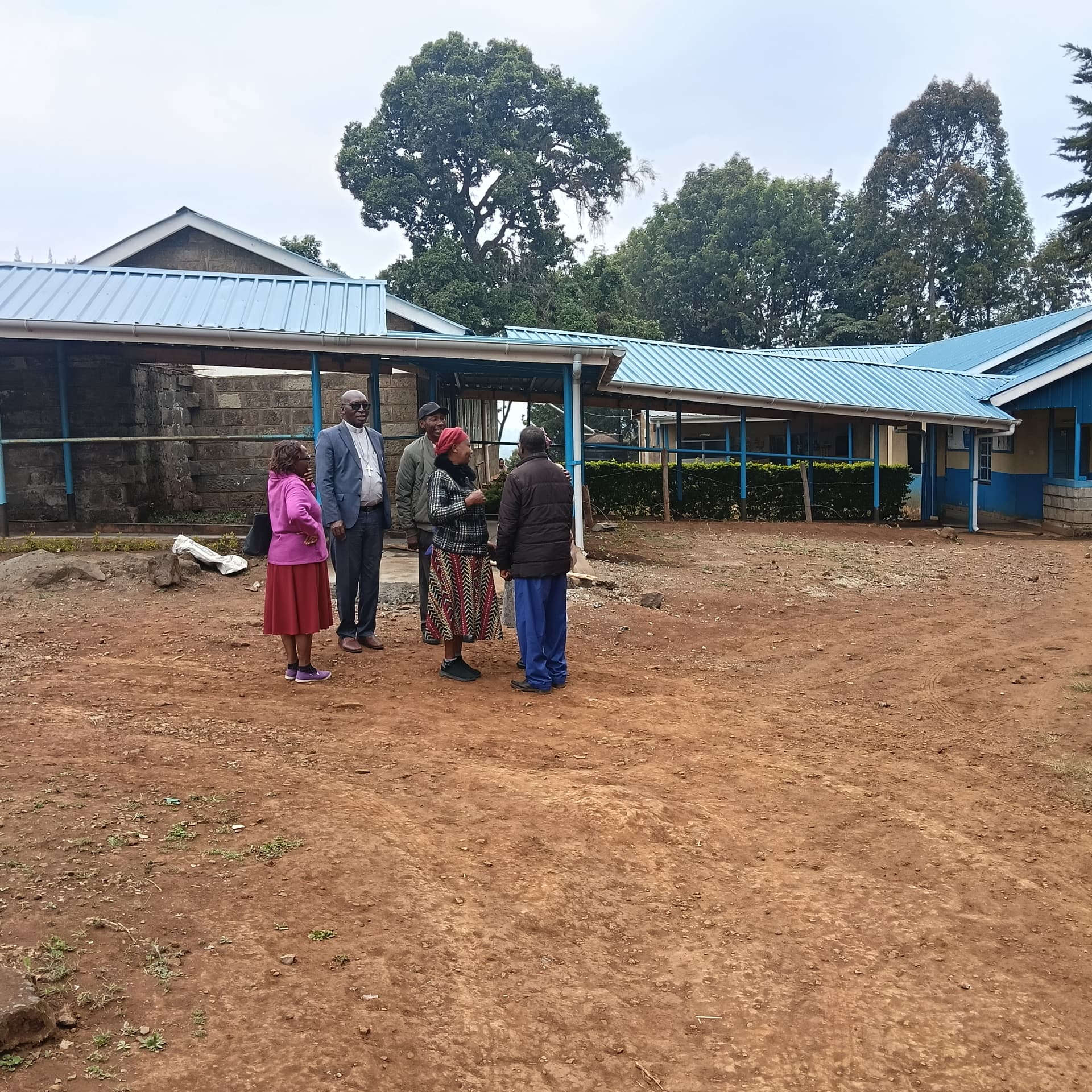 Outside the clinic on celebration day, with the new roof in place.